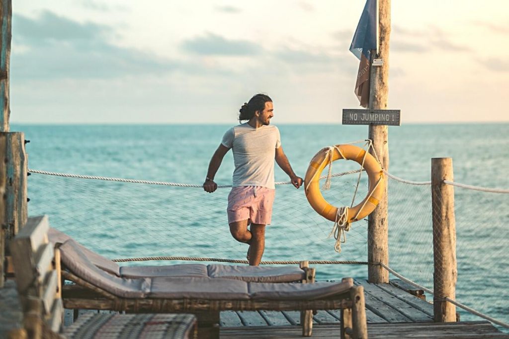 Illustration of a person enjoying the sea view on the beach airlie